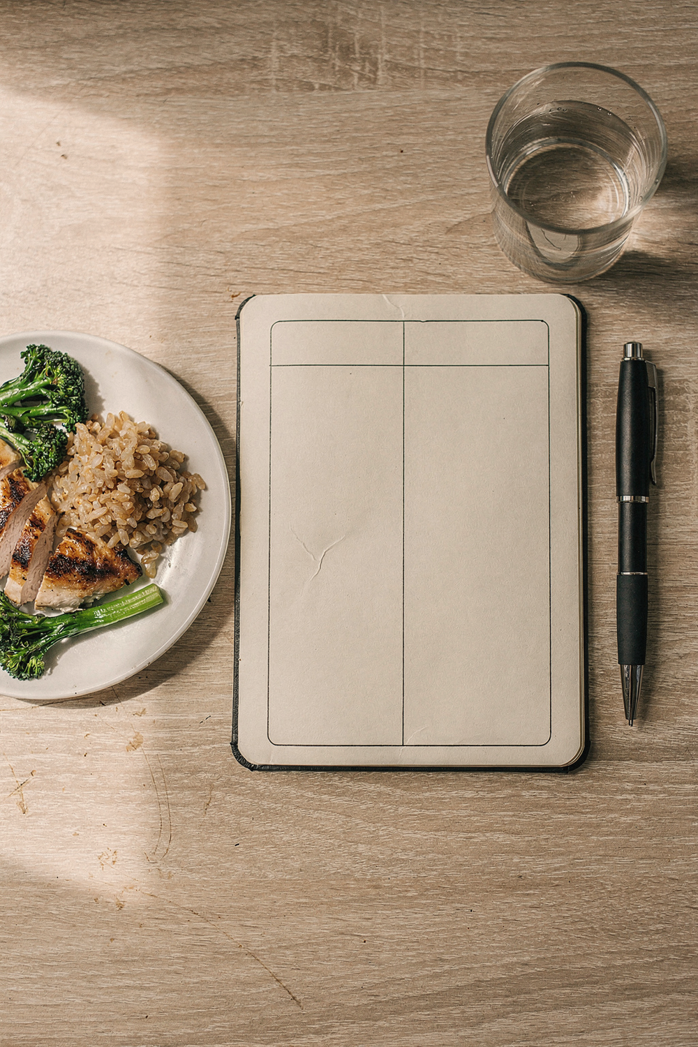 Journal and healthy meal on a wooden table
